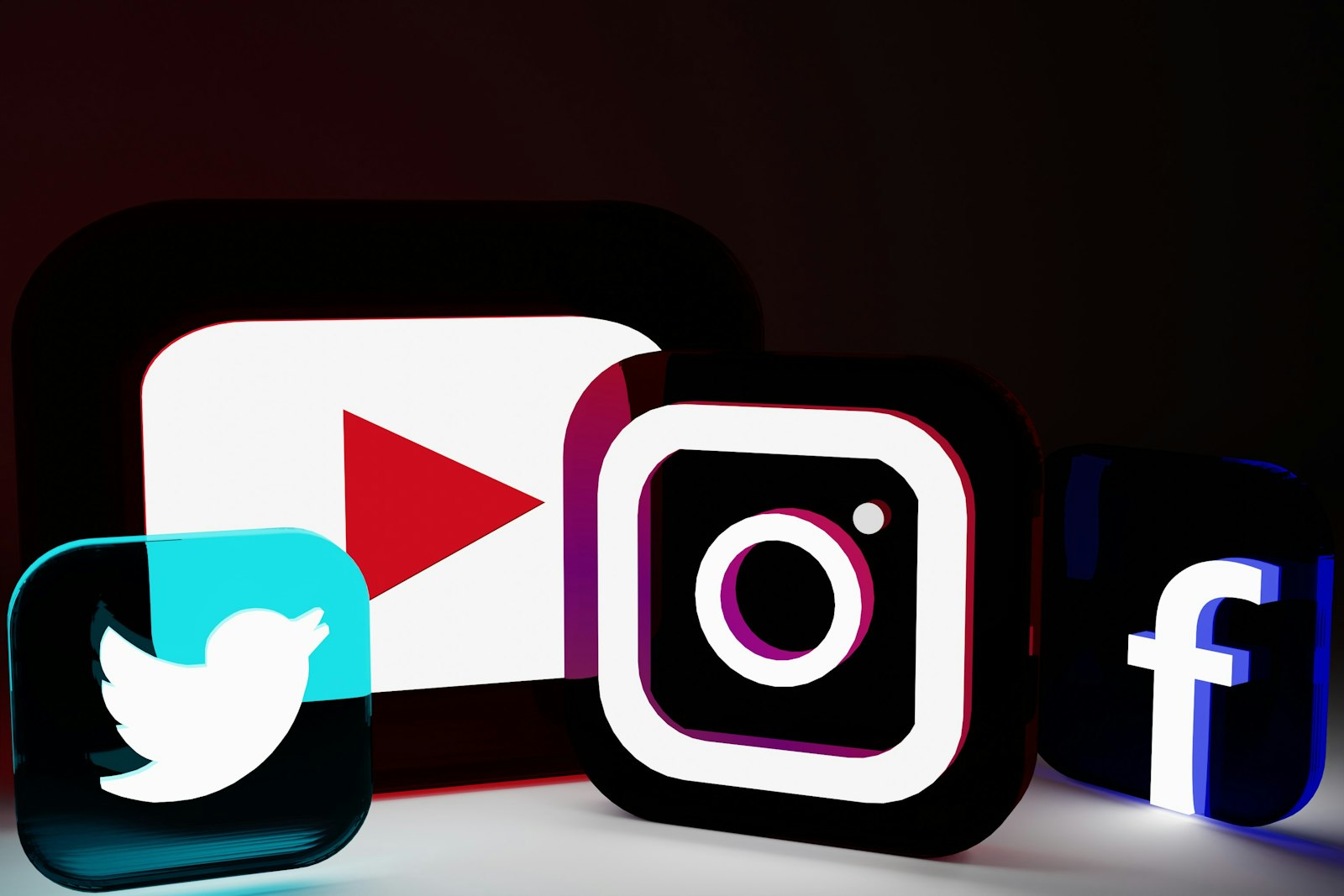Glowing 3D social media app logos including Instagram on a dark background