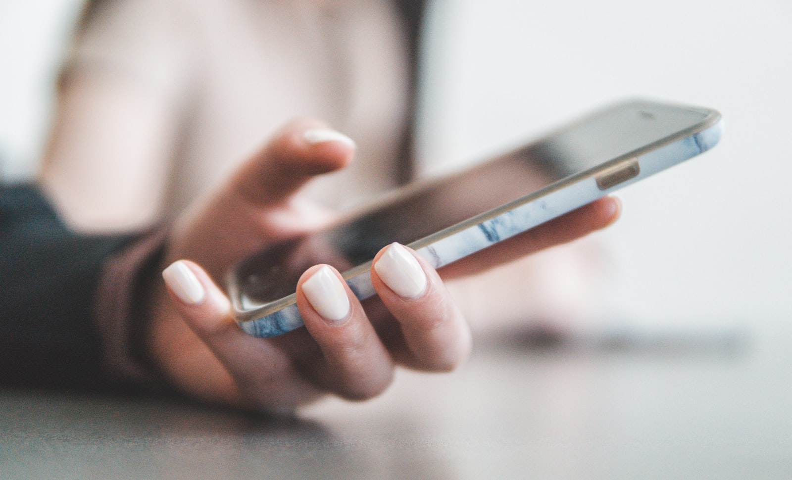 A hand holding a smartphone