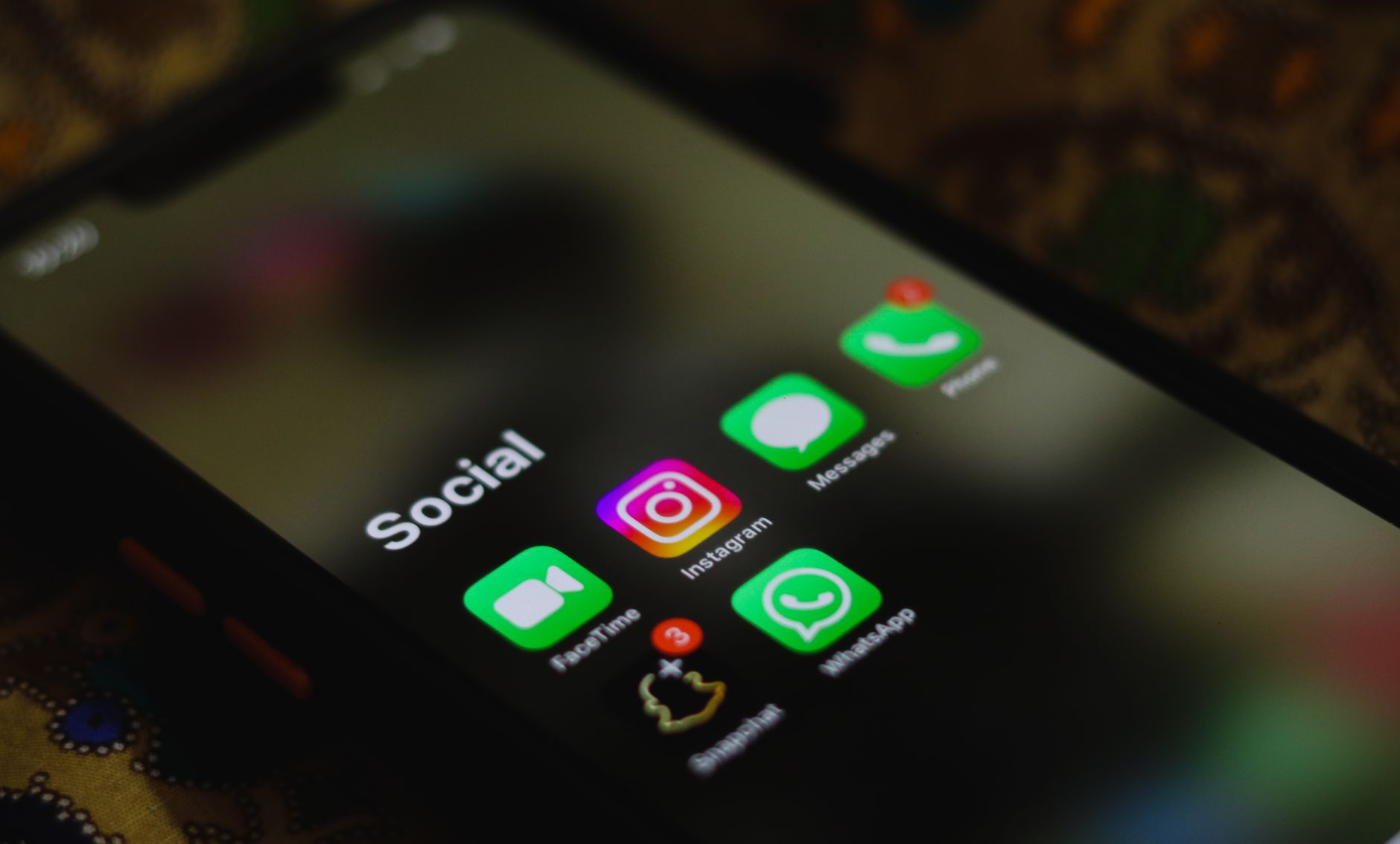 A close-up of a smartphone screen showing social media app icons, representing checking who unfollowed you on Threads