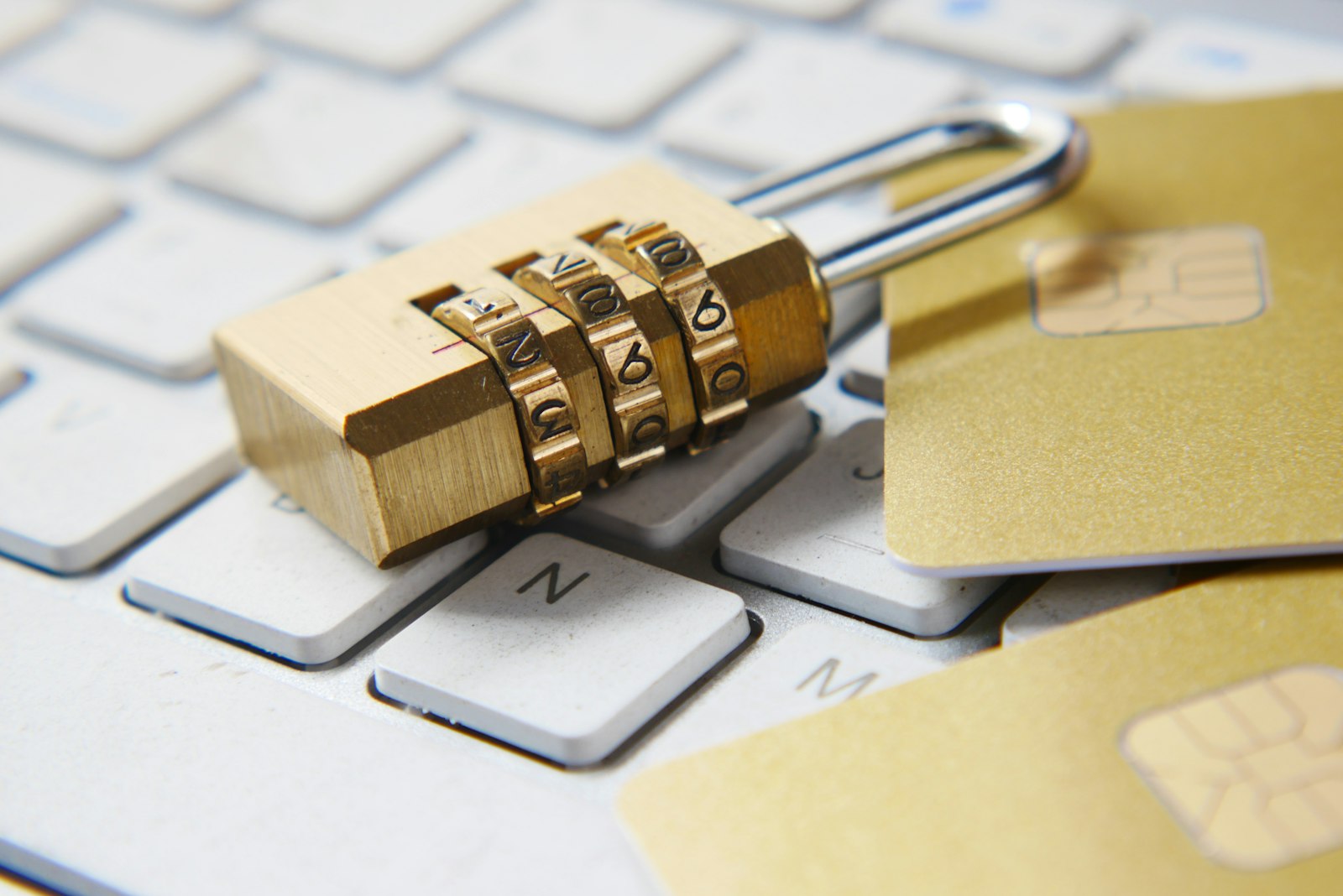 A padlock and credit cards resting on a keyboard, representing the safety risk of handing over Instagram credentials